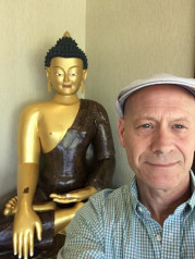 Wes Bethel with golden statue of the Buddah